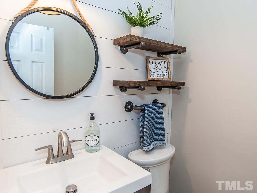 7605 Elliot Drive Raleigh, NC 27613 - Photo 14 of 22 a bathroom with a sink and mirror