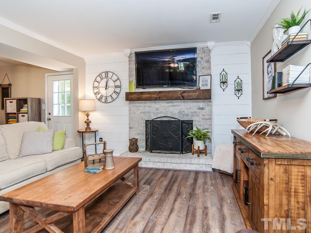 7605 Elliot Drive Raleigh, NC 27613 - Photo 7 of 22 a living room with furniture and a fireplace