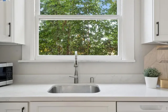 a bedroom with furniture and a large window