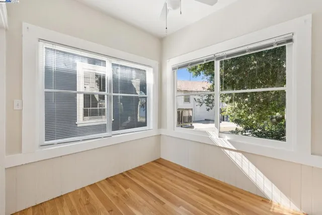 a view of a lake with a big yard and large trees