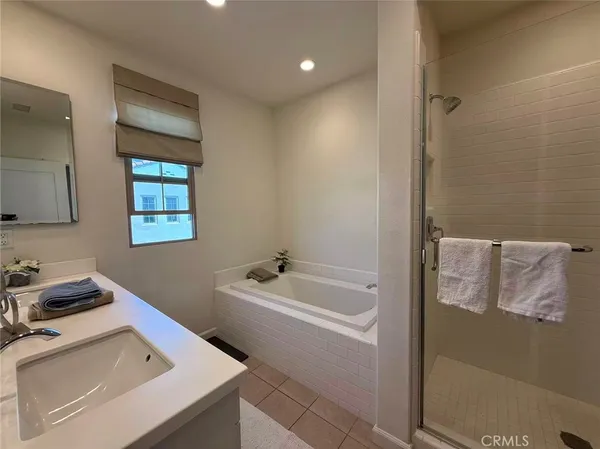 a bathroom with a tub sink and mirror