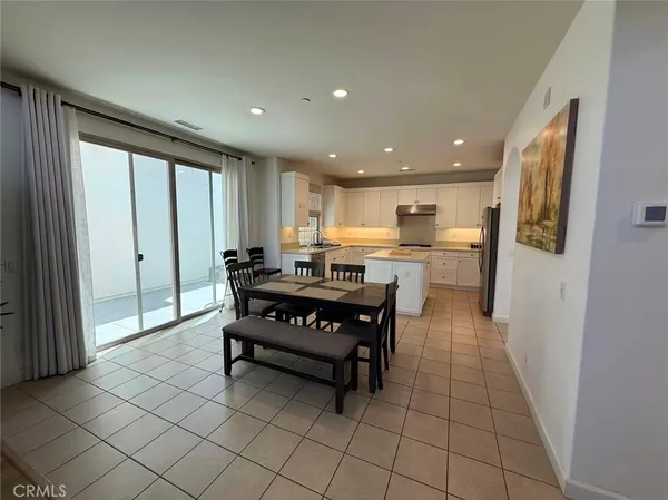 a kitchen with a refrigerator and a counter top space