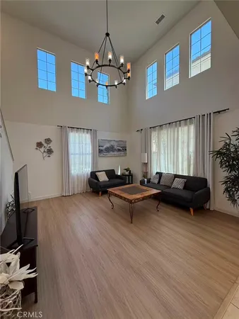 a living room with furniture and a chandelier