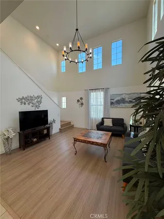 a living room with furniture a fireplace and a chandelier