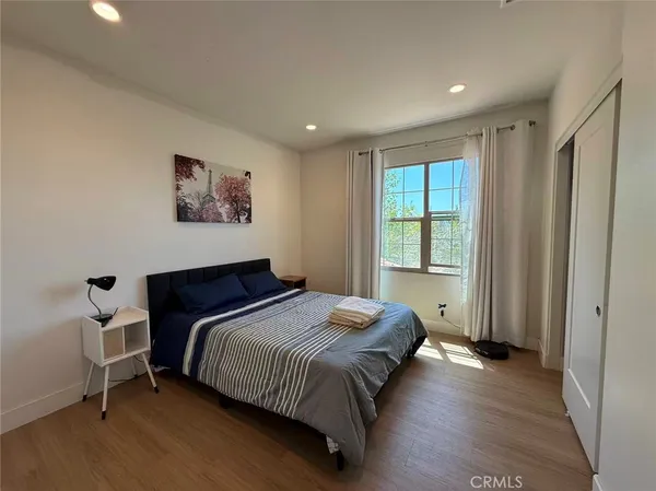 a bedroom with a bed and a window