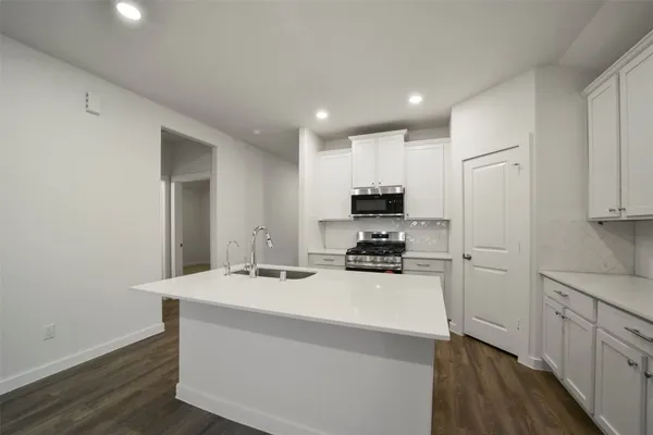 a kitchen with sink a stove and refrigerator