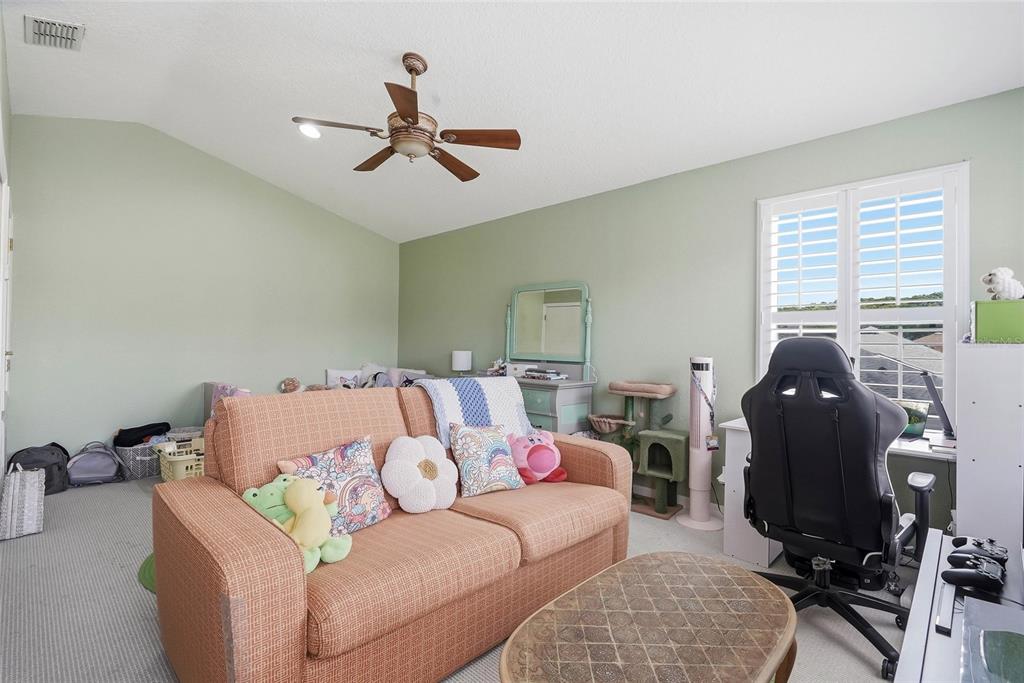 16748 Midsummer Lane Spring Hill, FL 34610 - Photo 33 of 52 a living room with furniture and a window