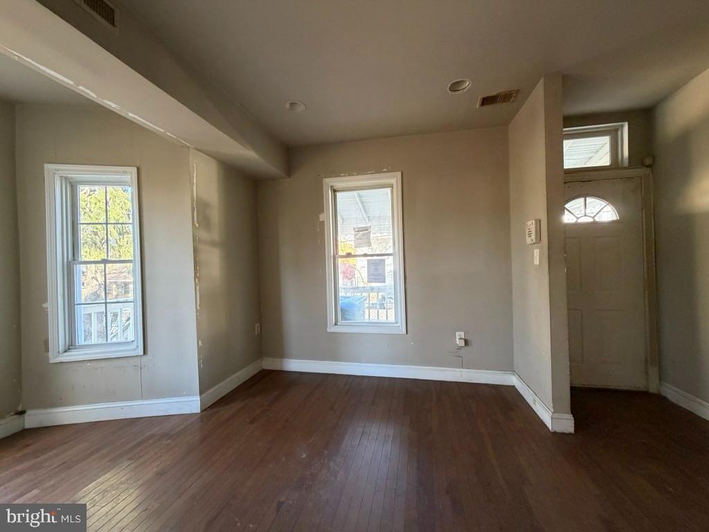 314 57th Street Northeast Washington, DC 20019 - Photo 2 of 19 an empty room with wooden floor and windows