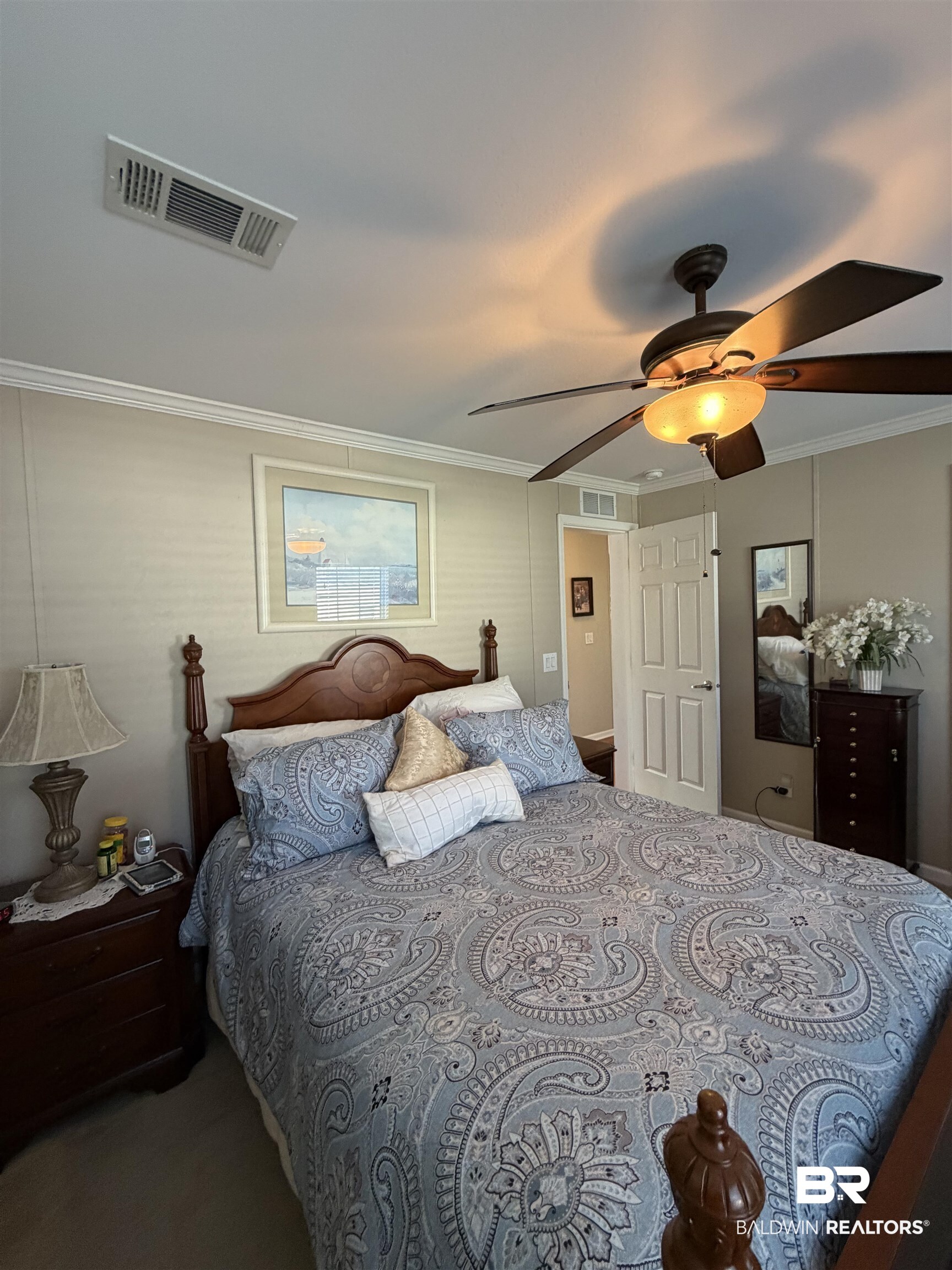 675 Escambia Loop Lillian, AL 36549 - Photo 19 of 44 Bedroom featuring a ceiling fan and crown molding
