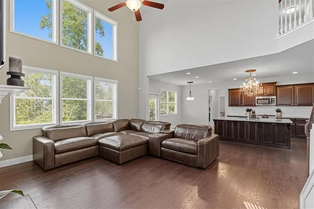a kitchen with kitchen island granite countertop a sink cabinets and refrigerator