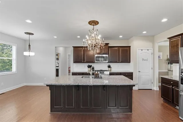 a kitchen with stainless steel appliances granite countertop a sink stove and oven