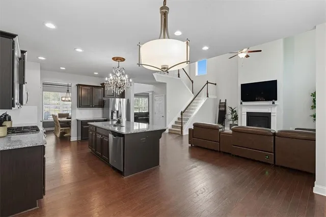 a dining room with furniture a chandelier and wooden floor