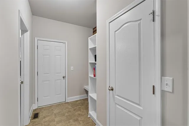 a spacious bathroom with a bathtub sink double vanity and mirror