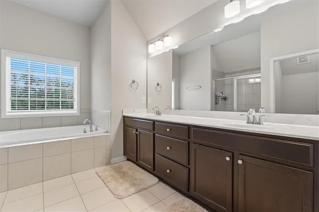 a bathroom with a double vanity sink and a mirror