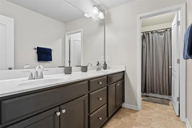 a bathroom with a toilet sink vanity and shower