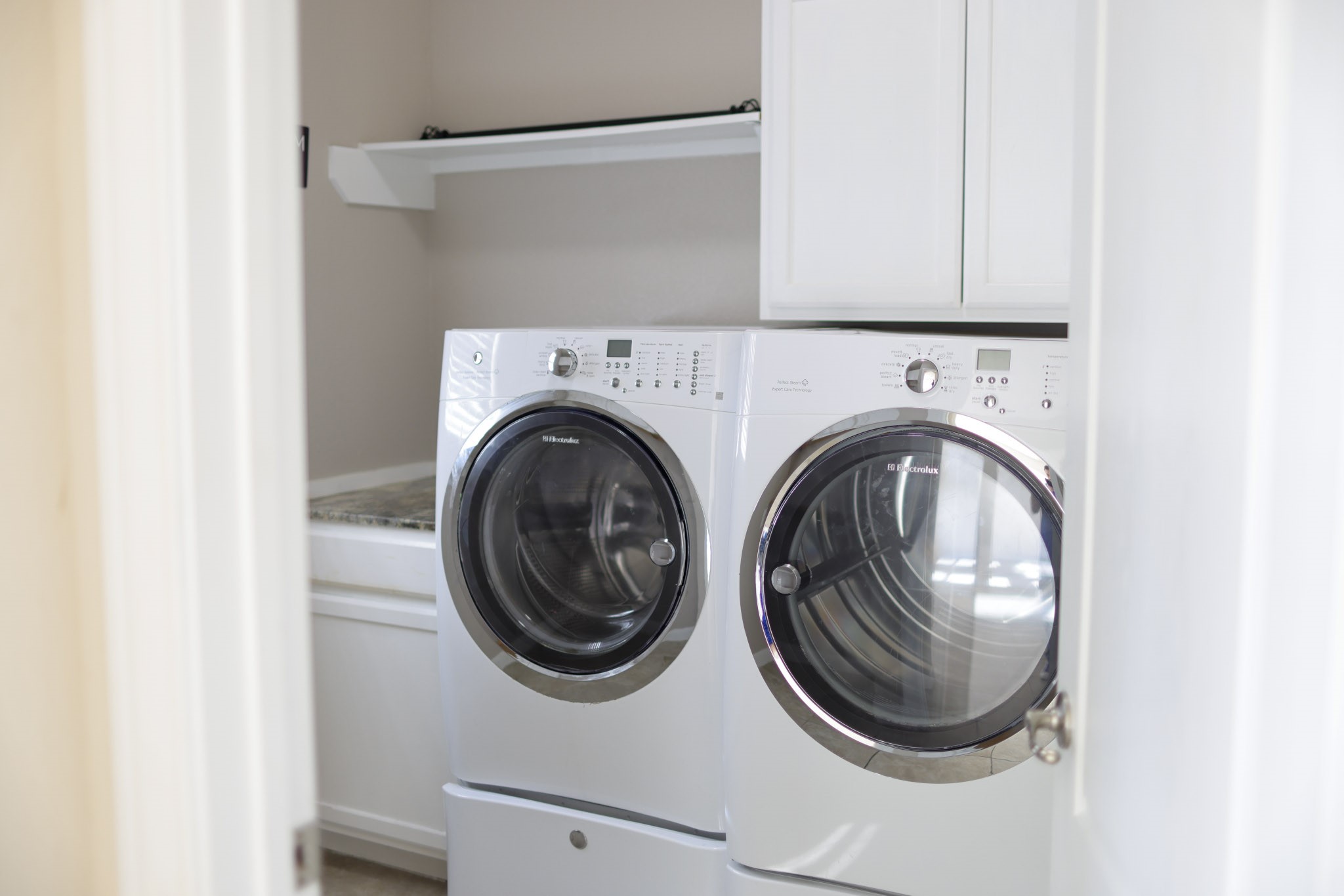 1236 Laurel Loop Angleton, TX 77515 - Photo 17 of 17 a close up view of a washer and dryer