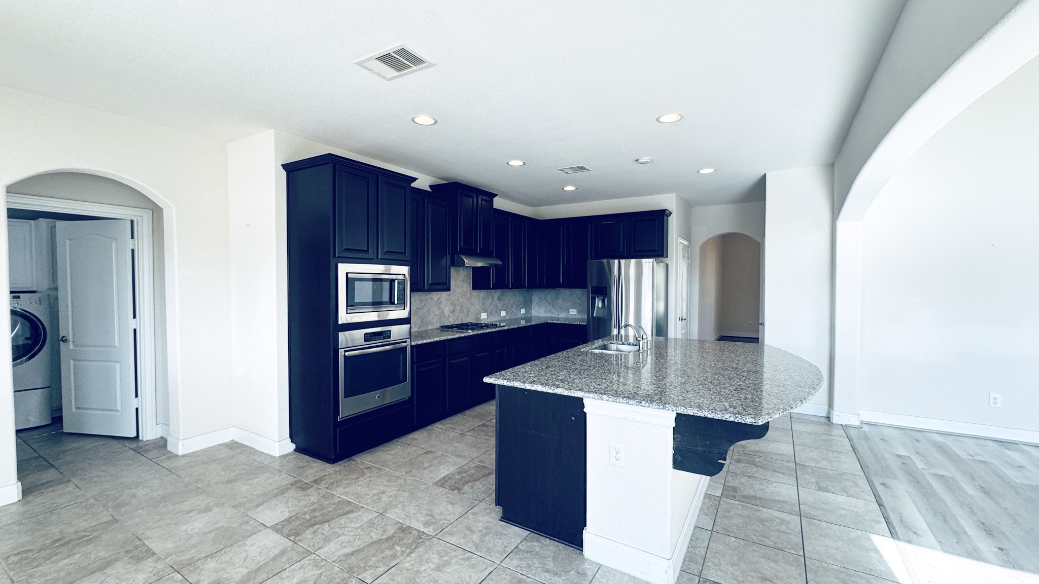 1236 Laurel Loop Angleton, TX 77515 - Photo 5 of 17 a kitchen with stainless steel appliances granite countertop a refrigerator and a sink