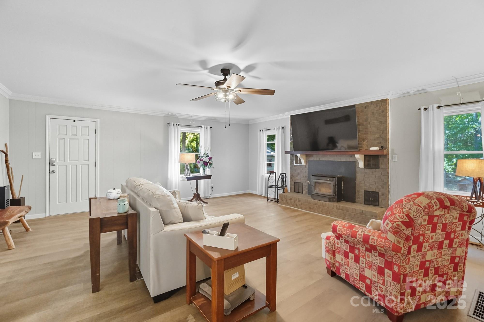 109 Carter Road Monroe, NC 28110 - Photo 13 of 48 a living room with furniture a fireplace and a flat screen tv