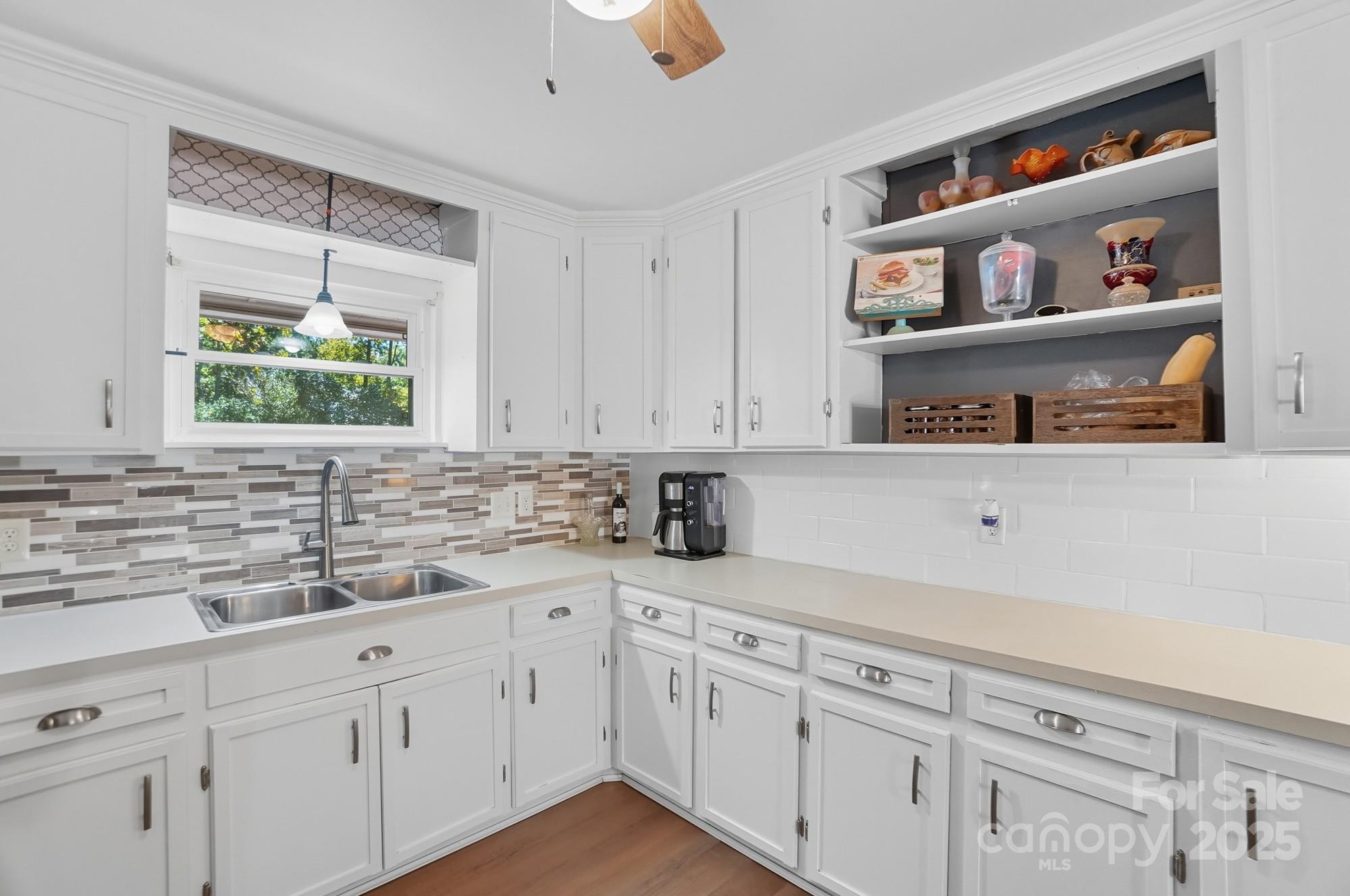 109 Carter Road Monroe, NC 28110 - Photo 20 of 48 a kitchen with stainless steel appliances white cabinets and a window