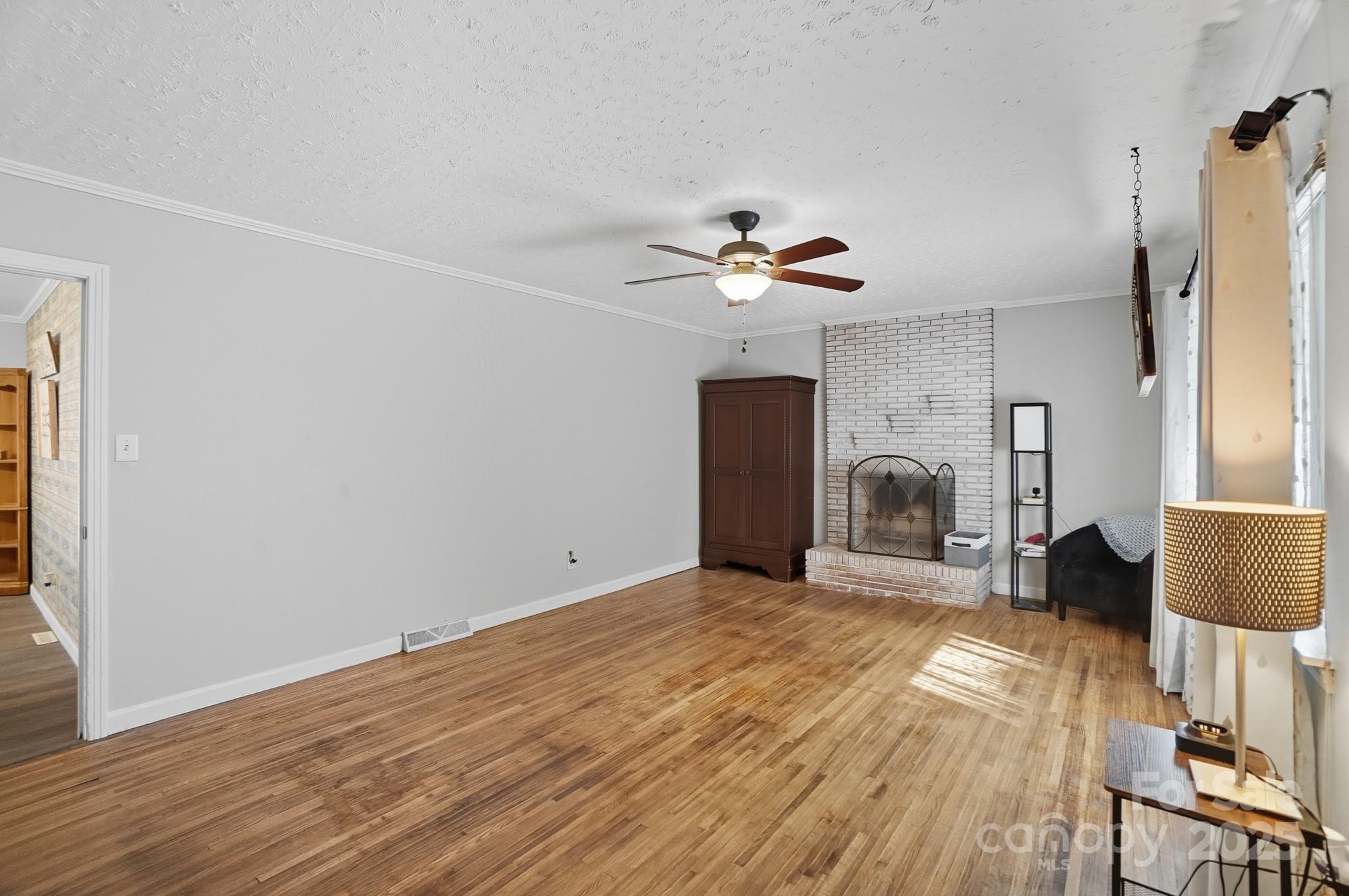 109 Carter Road Monroe, NC 28110 - Photo 26 of 48 a view of an empty room with a fireplace and wooden floor