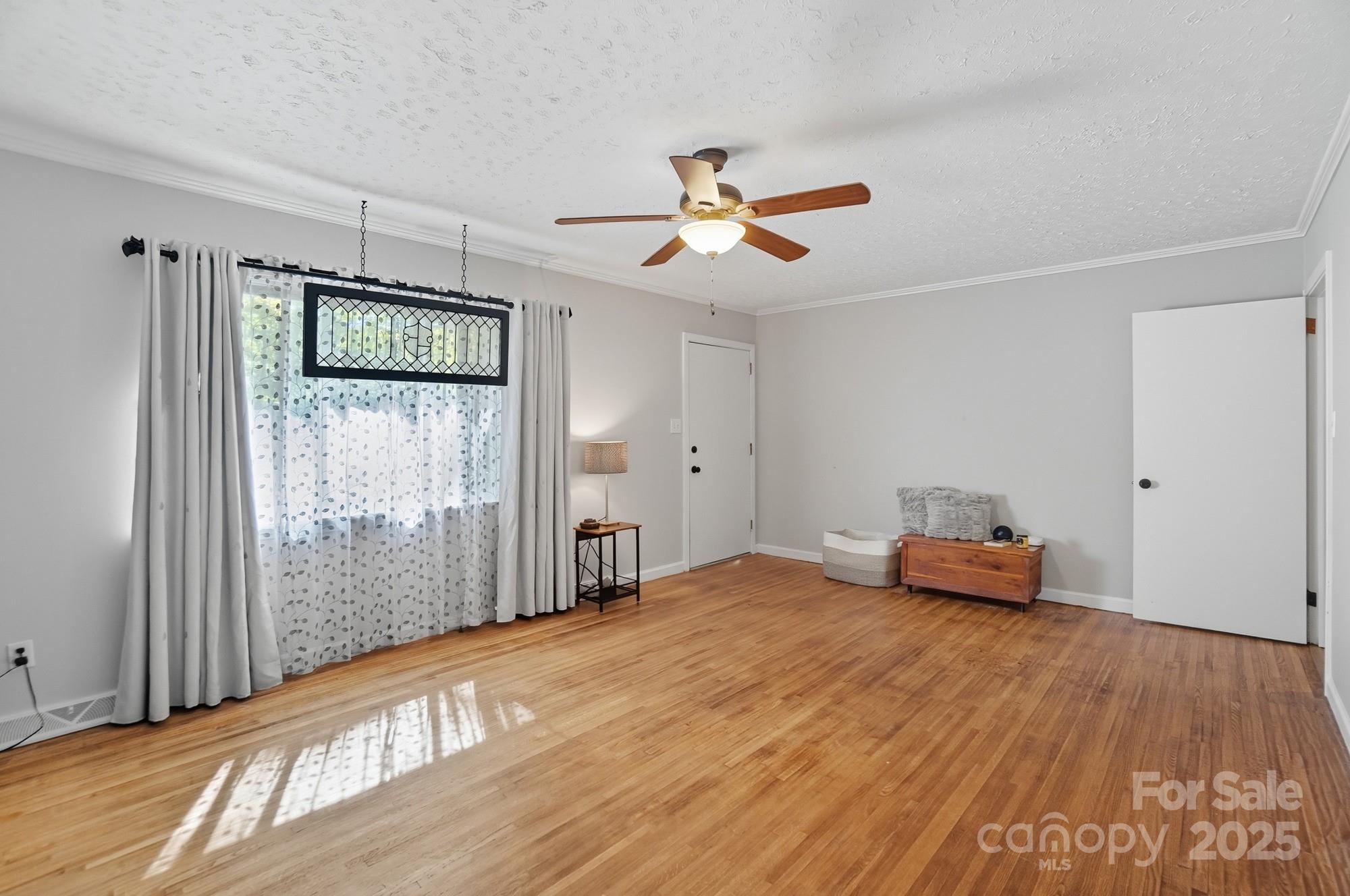 109 Carter Road Monroe, NC 28110 - Photo 28 of 48 a bedroom with a bed and a chandelier