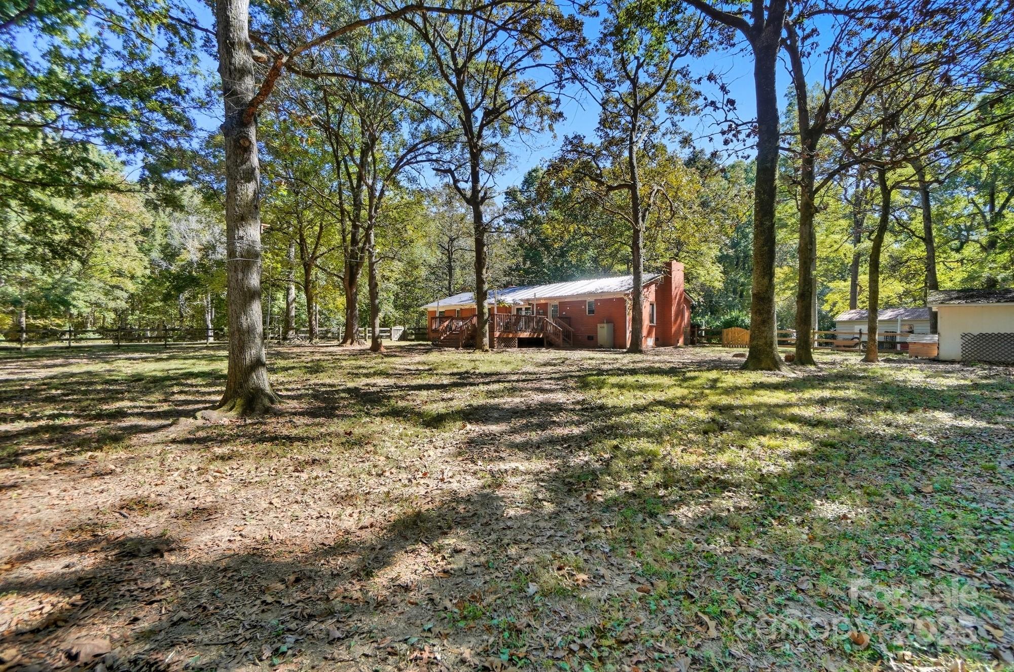 109 Carter Road Monroe, NC 28110 - Photo 44 of 48 a view of a green field with trees