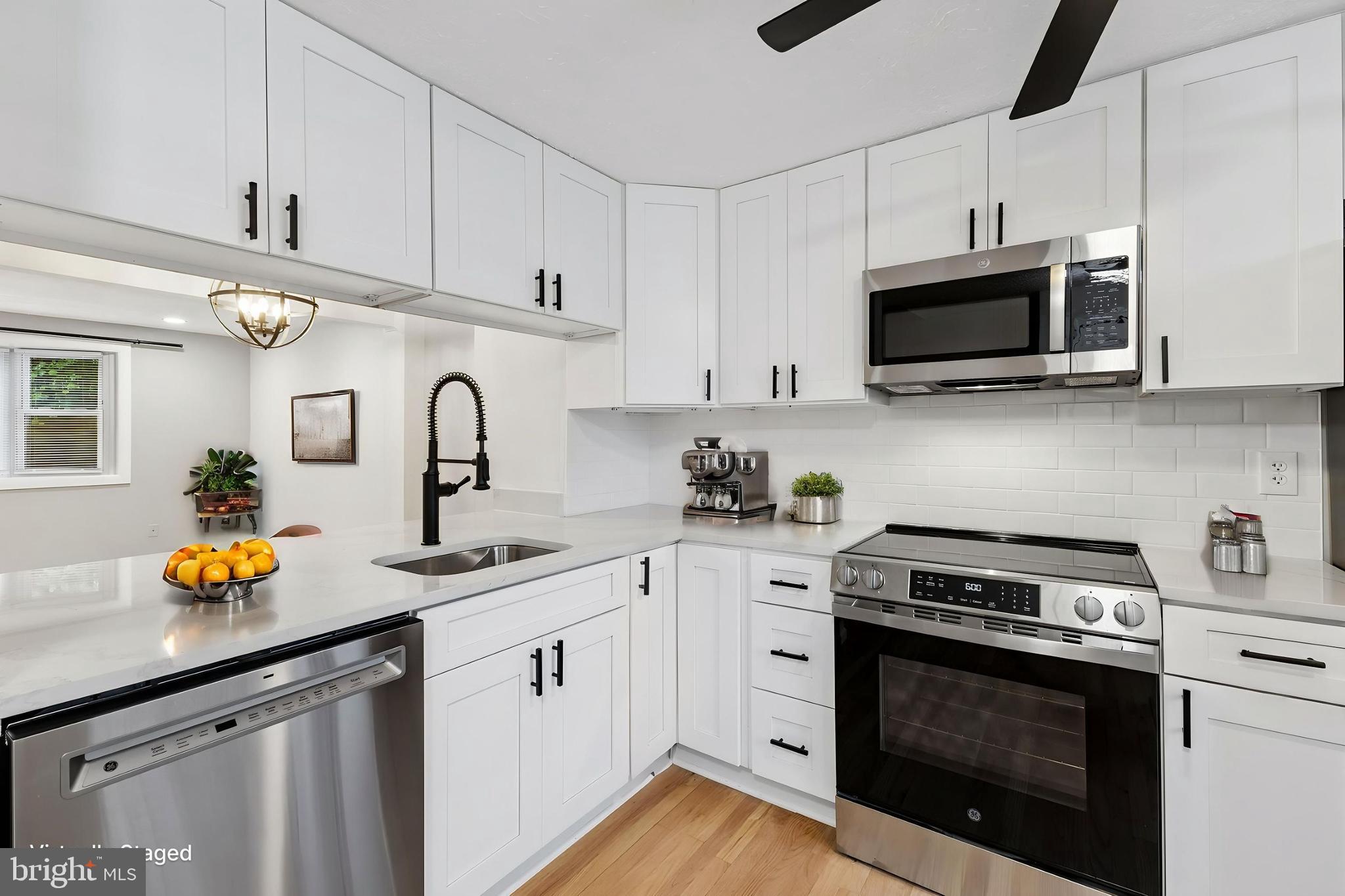 8317 Brookvale Court Springfield, VA 22153 - Photo 5 of 33 a kitchen with stainless steel appliances granite countertop a sink a stove and cabinets