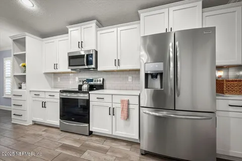 a kitchen with a sink appliances and cabinets