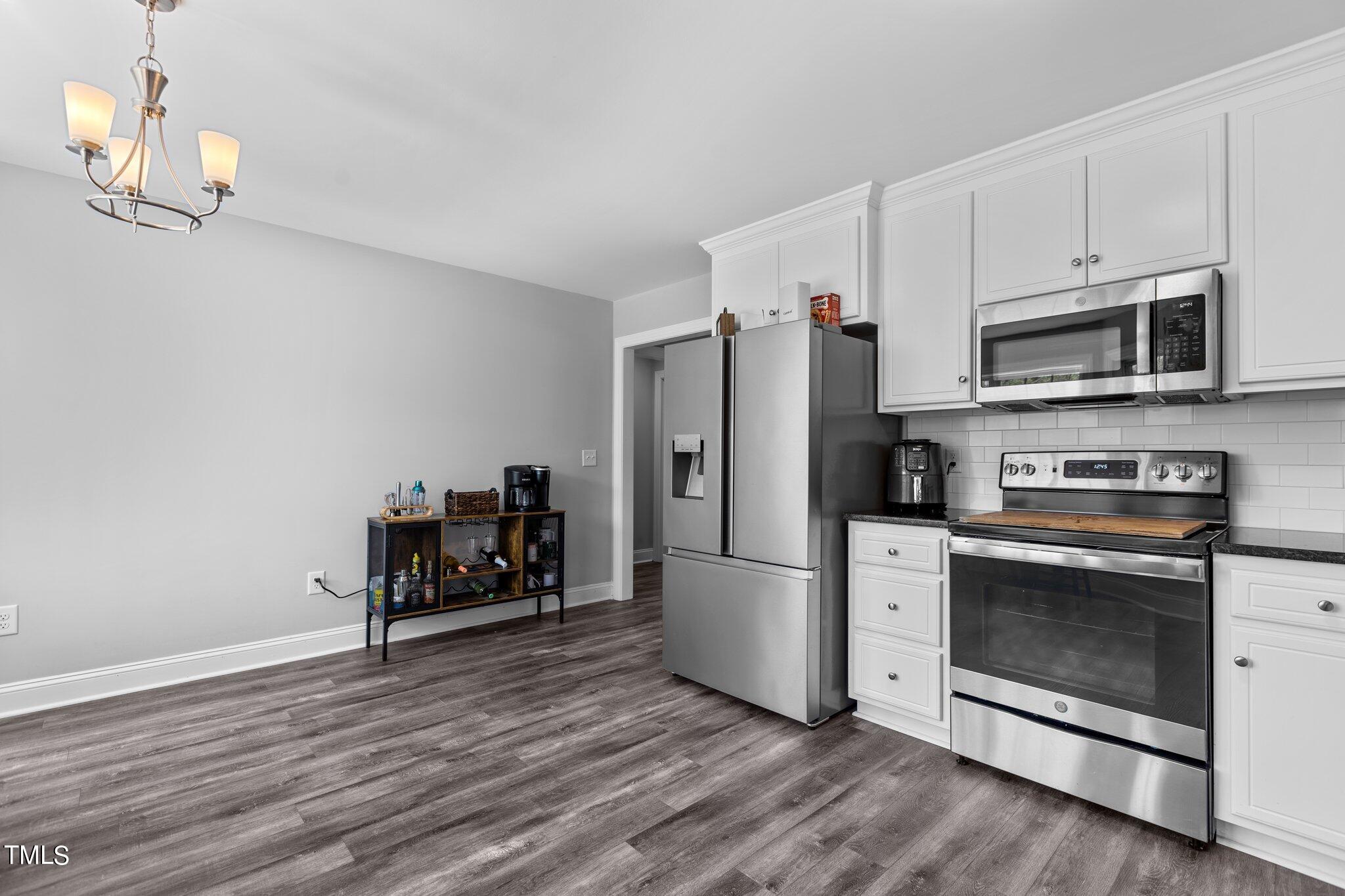 7089 Finch Road Bailey, NC 27807 - Photo 8 of 43 a kitchen with wooden cabinets and stainless steel appliances