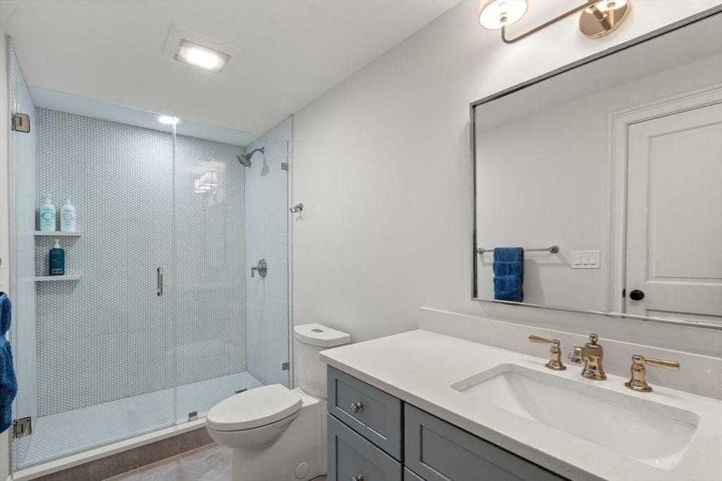7 Massasoit Road Wellesley, MA 02481 - Photo 37 of 42 a bathroom with a sink toilet vanity and shower