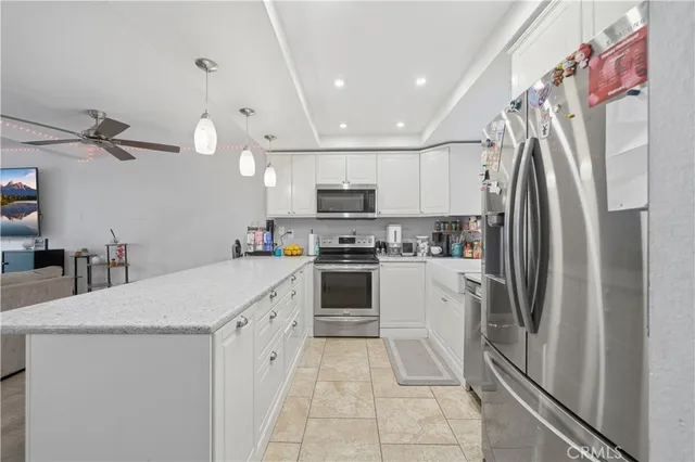 a kitchen with stainless steel appliances and white cabinets