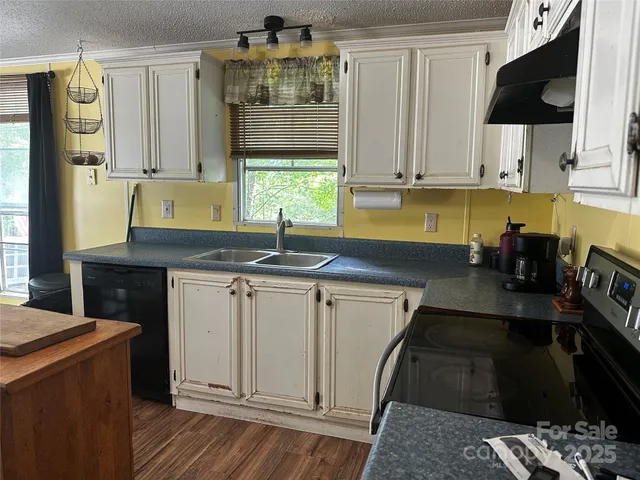 a kitchen with stainless steel appliances a sink stove and cabinets