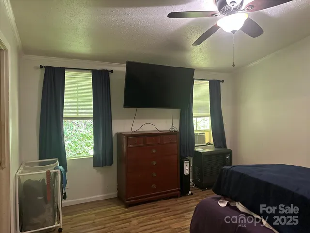 a bedroom with a bed and a television