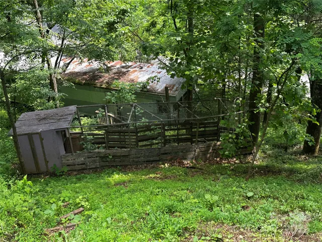 a view of a garden with wooden fence
