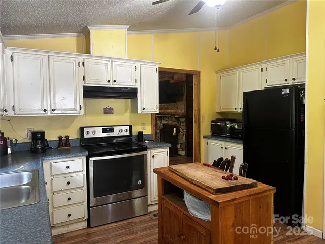 a kitchen with stainless steel appliances a stove a refrigerator and a cabinets