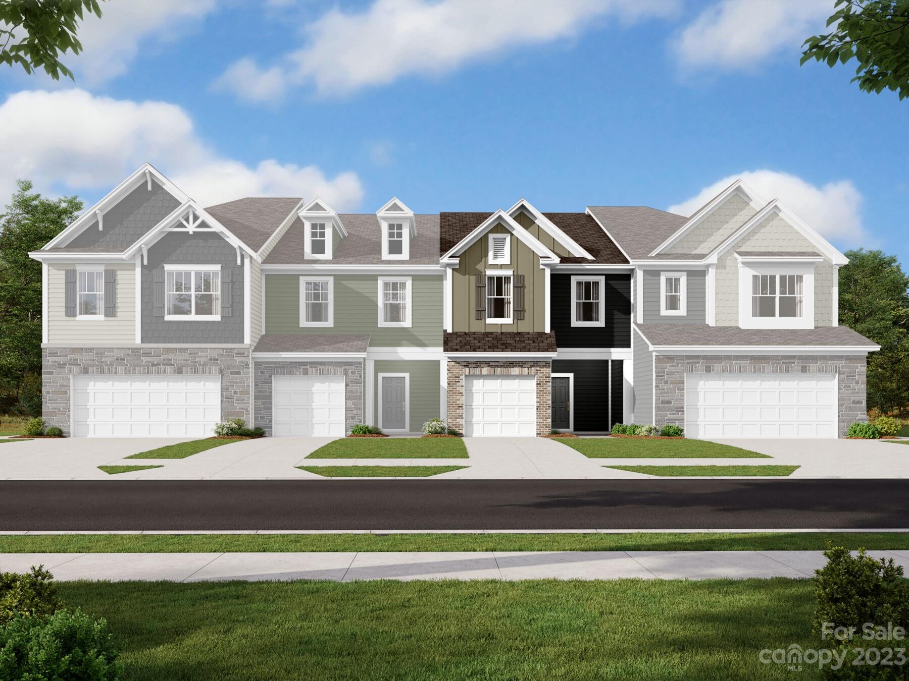 a front view of a house with a garden and lake view