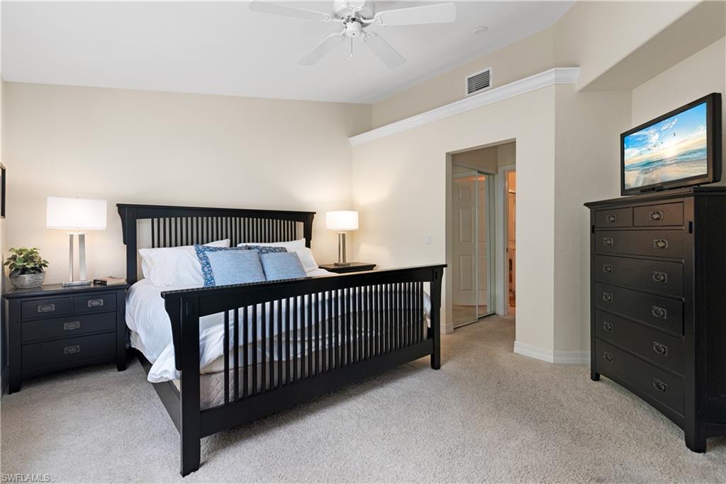 15079 Sterling Oaks Drive Naples, FL 34110 - Photo 11 of 29 a bedroom with a bed and a tv on the dresser