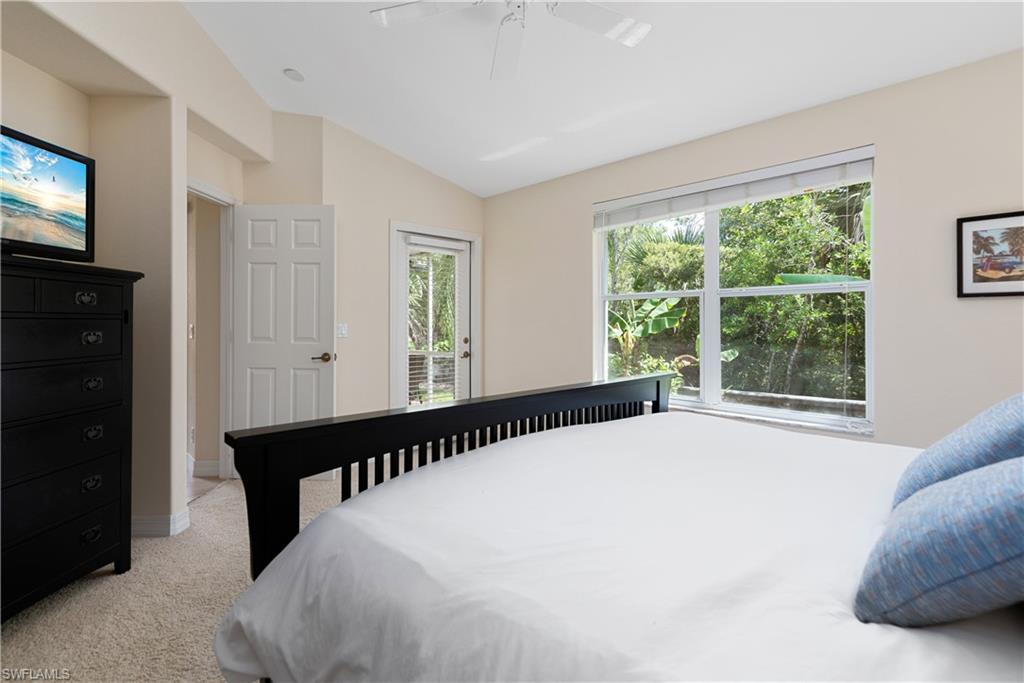 15079 Sterling Oaks Drive Naples, FL 34110 - Photo 12 of 29 a bed sitting in a bedroom next to a window