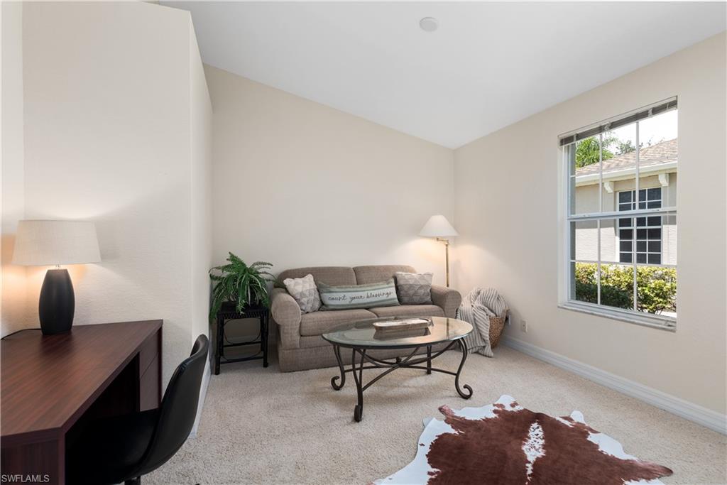 15079 Sterling Oaks Drive Naples, FL 34110 - Photo 14 of 29 a living room with furniture and a window