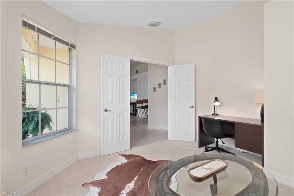 15079 Sterling Oaks Drive Naples, FL 34110 - Photo 15 of 29 a bedroom with bed and a window