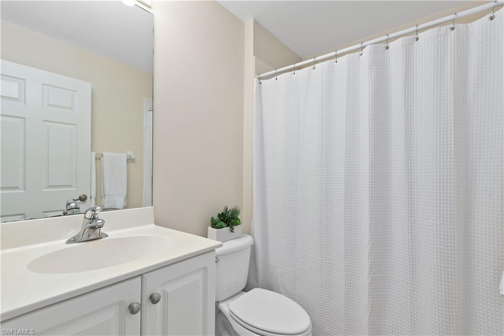 15079 Sterling Oaks Drive Naples, FL 34110 - Photo 17 of 29 a bathroom with a sink toilet and shower