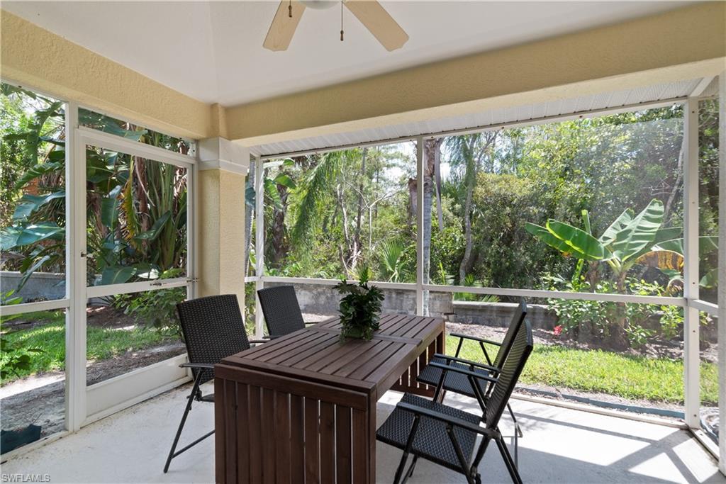15079 Sterling Oaks Drive Naples, FL 34110 - Photo 19 of 29 a view of a patio with a table chairs and a table