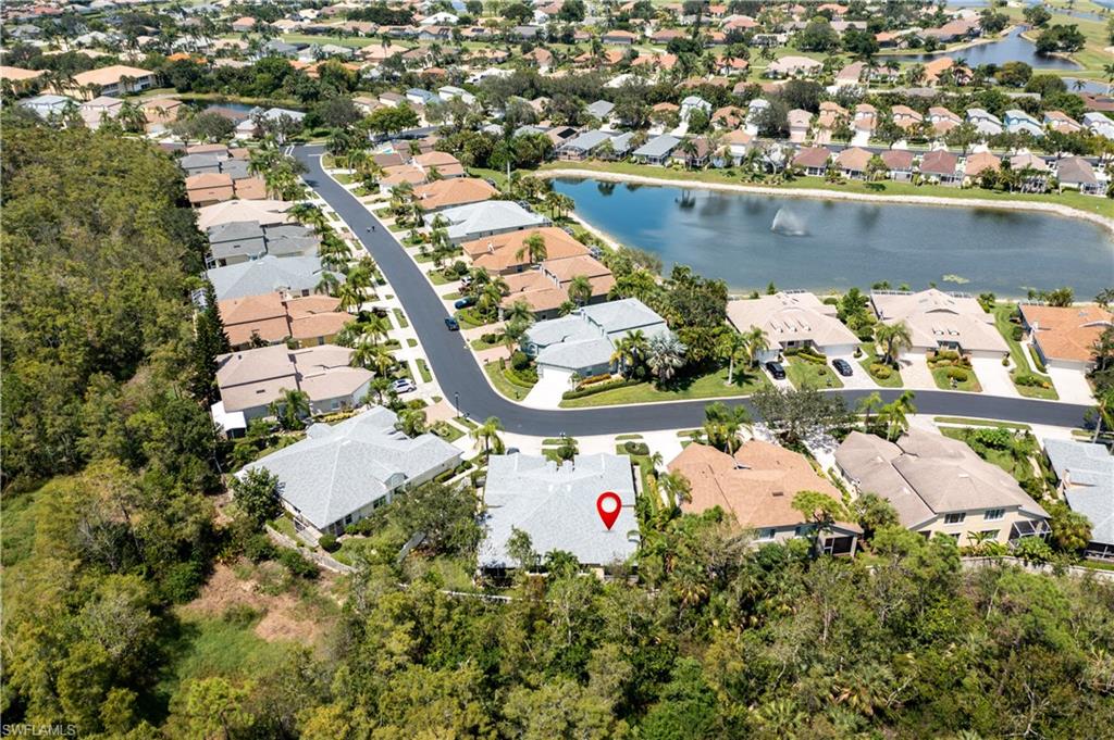15079 Sterling Oaks Drive Naples, FL 34110 - Photo 23 of 29 an aerial view of a house with a lake view