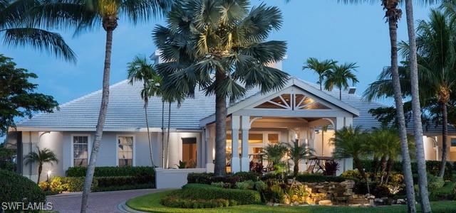 15079 Sterling Oaks Drive Naples, FL 34110 - Photo 26 of 29 a front view of a house with garden