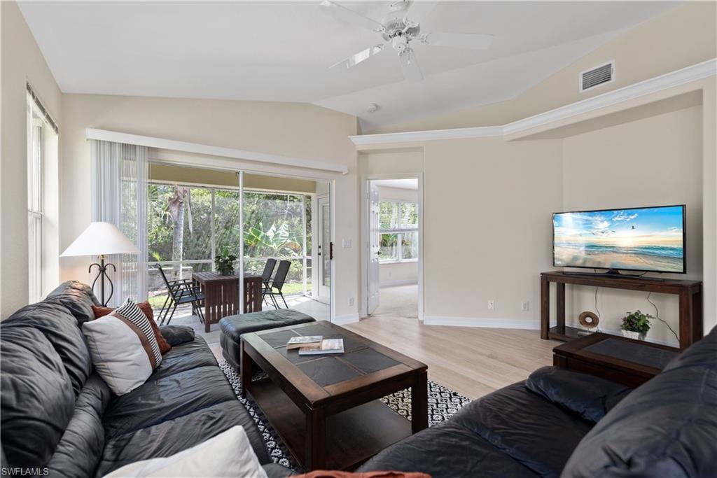 15079 Sterling Oaks Drive Naples, FL 34110 - Photo 3 of 29 a living room with furniture and a flat screen tv