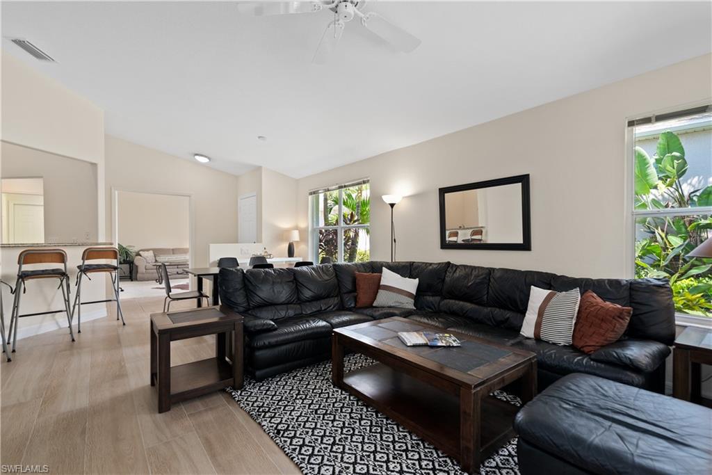15079 Sterling Oaks Drive Naples, FL 34110 - Photo 4 of 29 a living room with furniture and a rug
