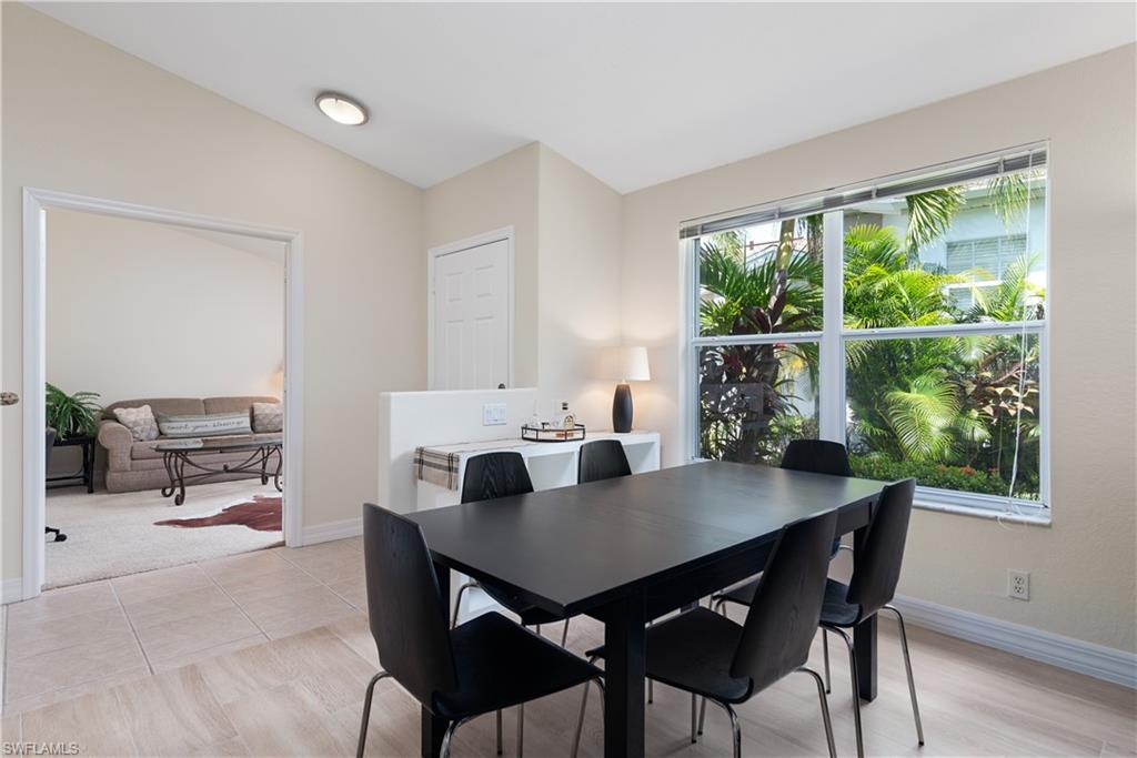 15079 Sterling Oaks Drive Naples, FL 34110 - Photo 5 of 29 a view of a dining room with a table and chairs