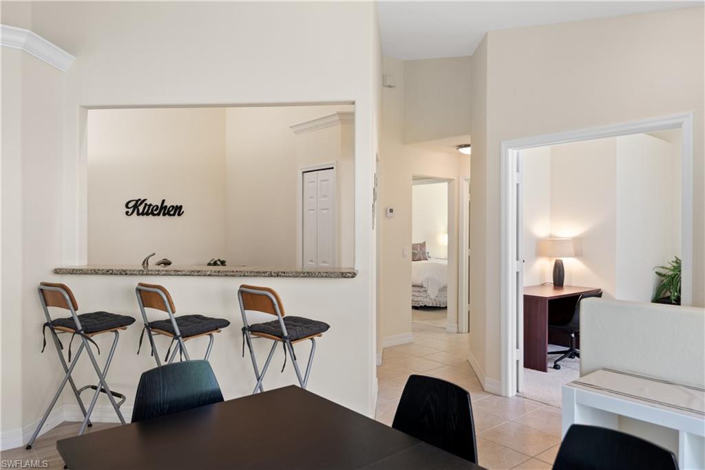 15079 Sterling Oaks Drive Naples, FL 34110 - Photo 6 of 29 a view of workspace and livingroom with furniture