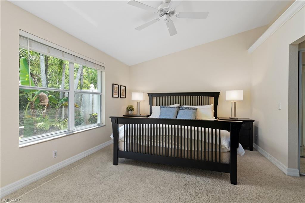 15079 Sterling Oaks Drive Naples, FL 34110 - Photo 10 of 29 a view of a bedroom with furniture and balcony