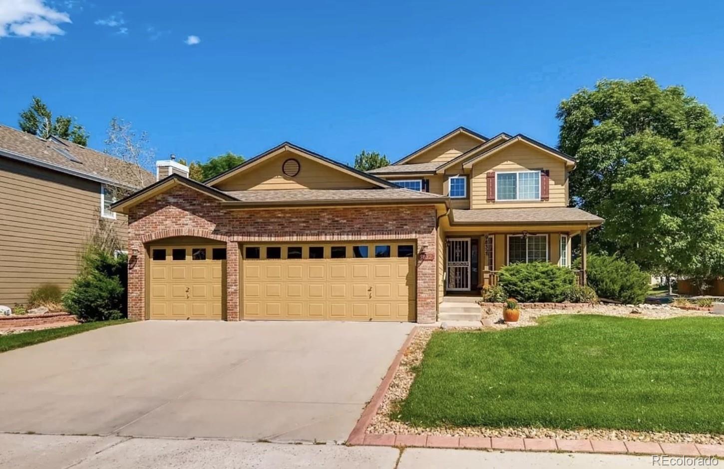 9832 South Spring Hill Place Highlands Ranch, CO 80129 - Photo 1 of 25 a front view of a house with a yard